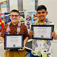 Carlos Gomez and Alexis Batres holding their Youth Appreciation Recognition plaques.